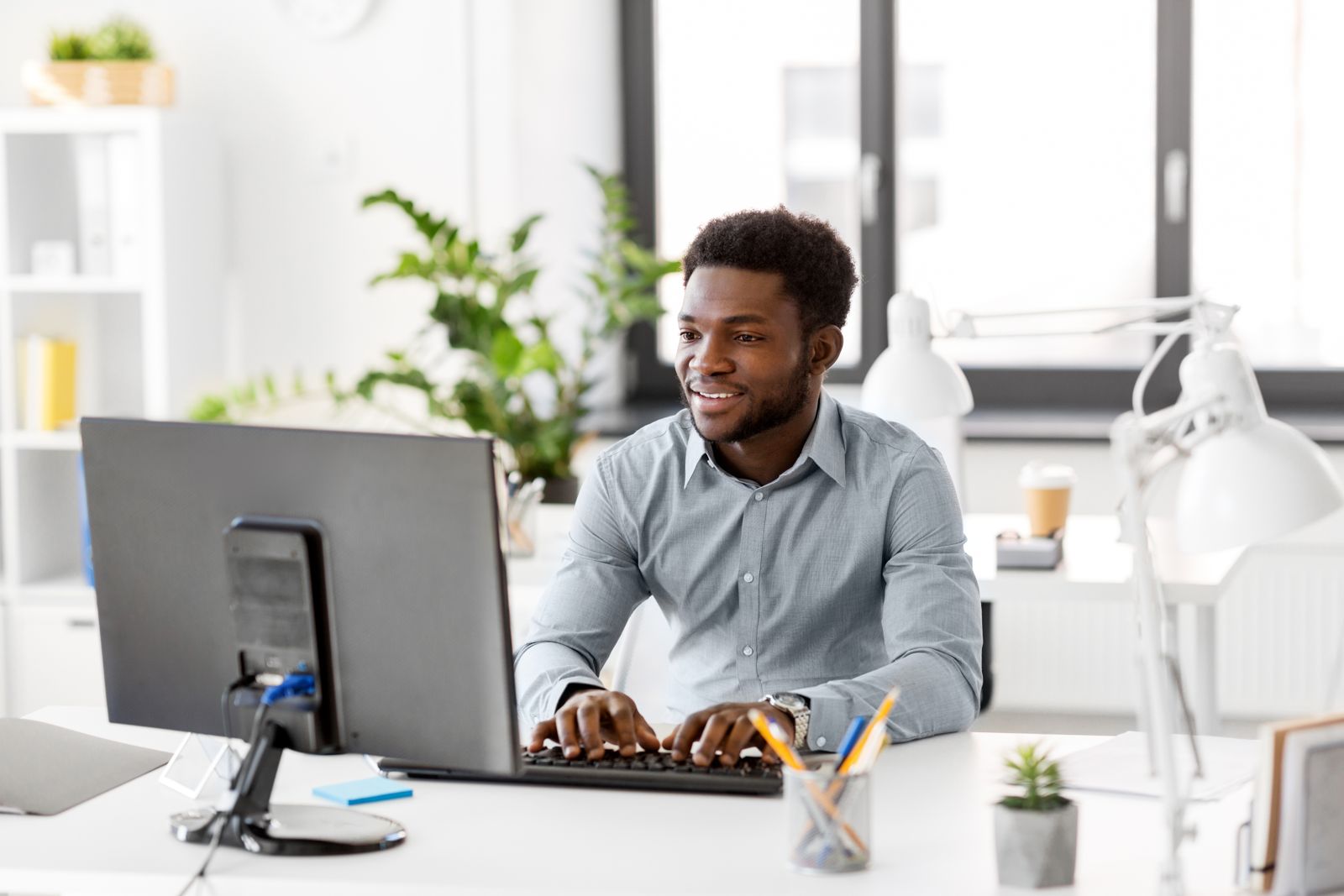 Team member preparing a client proposal at a computer